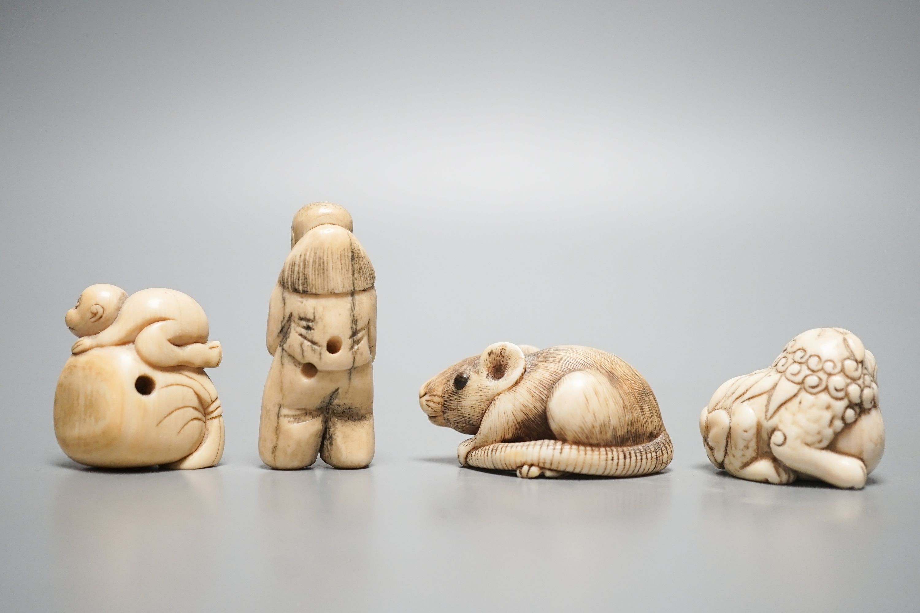 A 19th century ivory netsuke of a rat, horn inset eyes, 5.2cm, two other ivory netsuke and a stag horn netsuke (4)